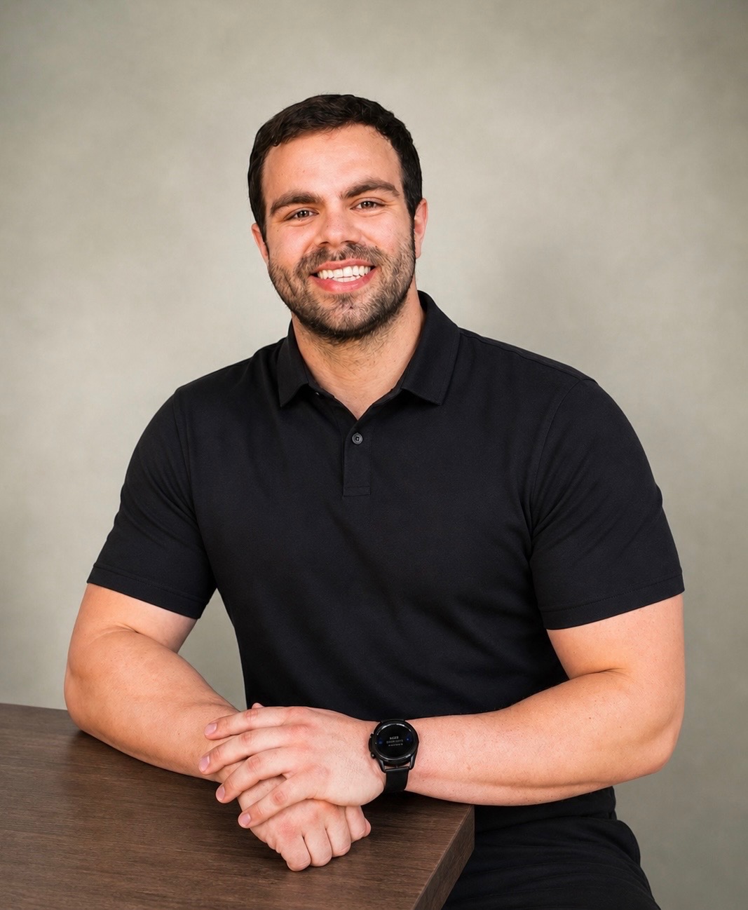Get Scrawny coach smiling in a black polo shirt